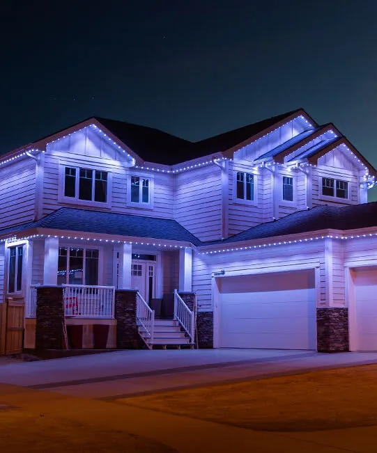Gemstone Lights permanent LED track lighting on a two-story home at night